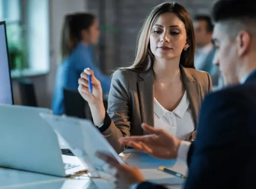 Corporate professionals in a meeting discussing documents